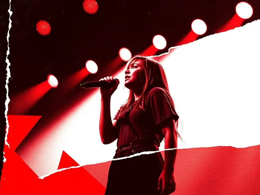 Label artist performing live on stage under red lights